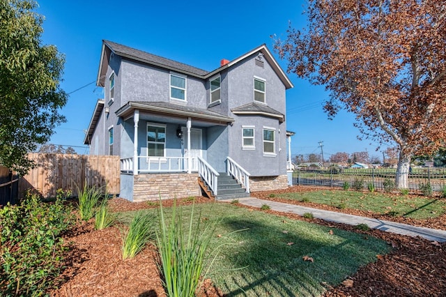 view of front of home featuring covered porch and a front yard