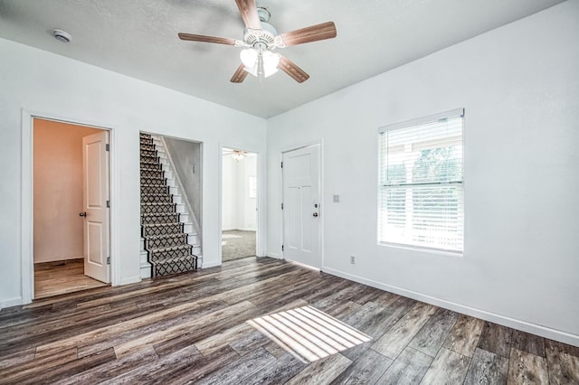 spare room with ceiling fan and dark hardwood / wood-style flooring