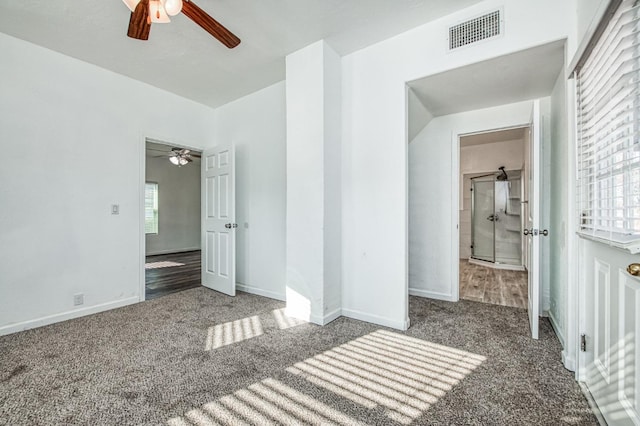 unfurnished bedroom with carpet floors, multiple windows, and ceiling fan