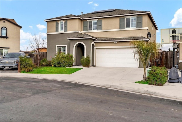 view of front of house featuring a garage and solar panels