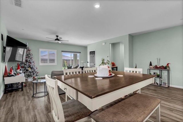 dining space with ceiling fan and hardwood / wood-style flooring