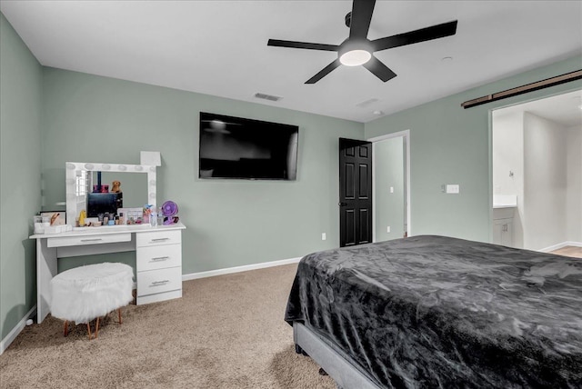 bedroom featuring a barn door, ceiling fan, and carpet flooring