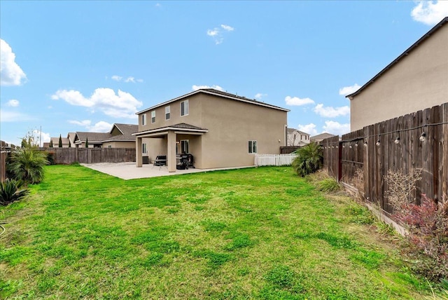 back of property featuring a patio and a lawn