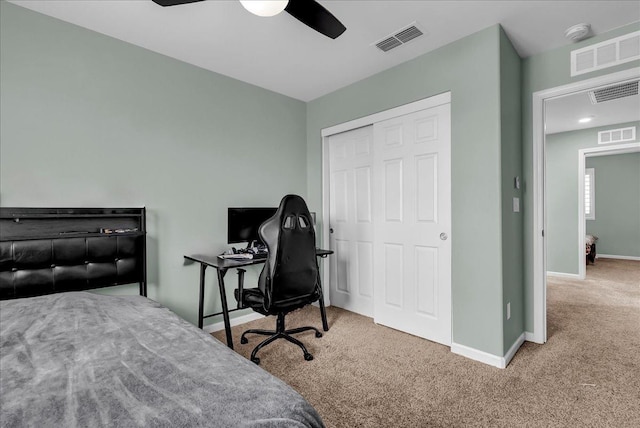 carpeted bedroom featuring ceiling fan and a closet