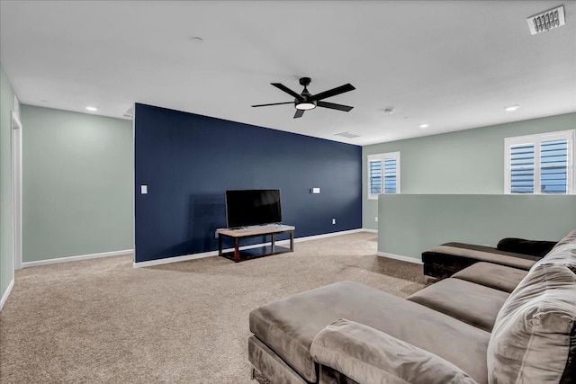 carpeted living room with ceiling fan