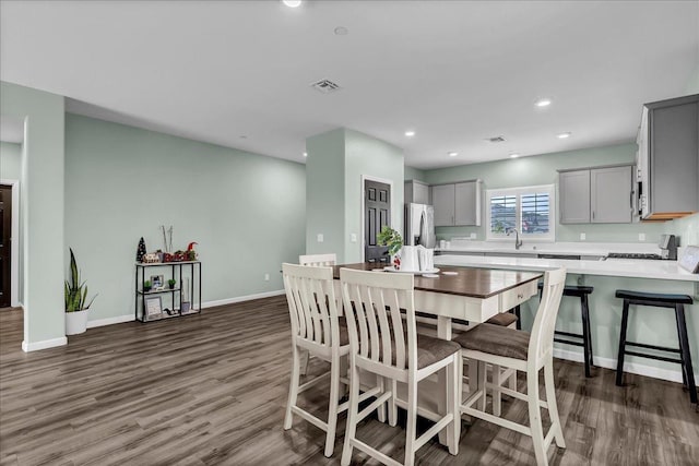 dining room featuring dark wood-type flooring and sink