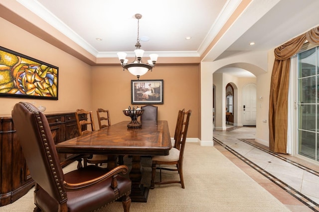 1445 E Via Roma Dr, Fresno, CA 93730 - dining area with arched walkways, a chandelier, a tray ceiling, ornamental molding, and baseboards