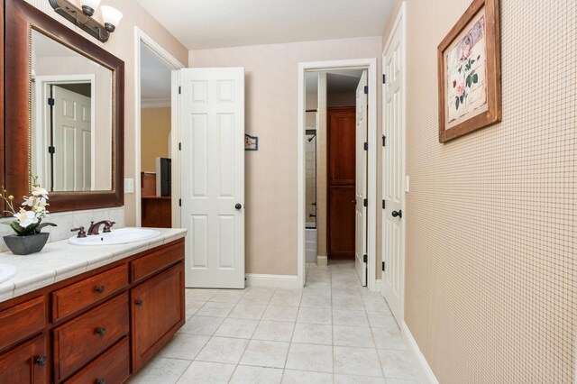 1445 E Via Roma Dr, Fresno, CA 93730 - full bath featuring tile patterned floors, double vanity, and baseboards