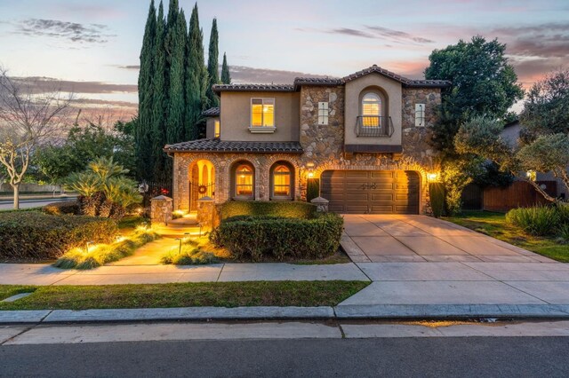 mediterranean / spanish house with a garage