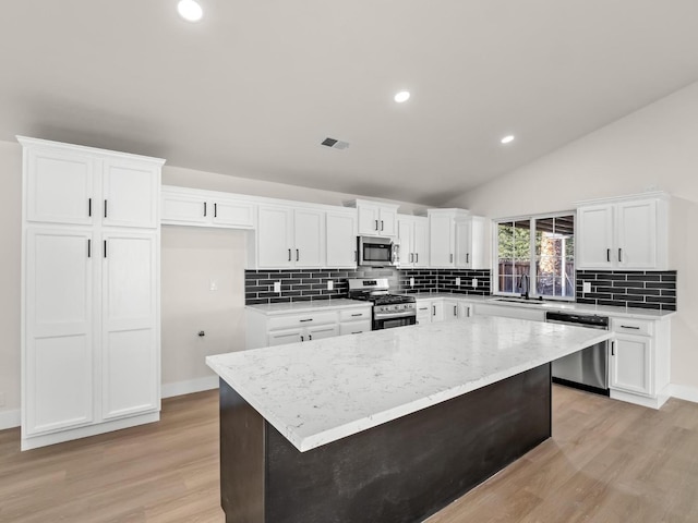 kitchen with white cabinets, a center island, and stainless steel appliances