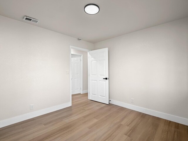 spare room with light hardwood / wood-style floors