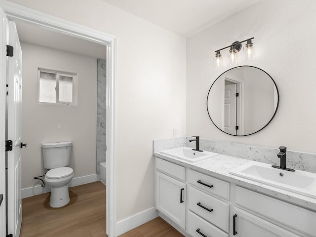 full bathroom featuring toilet, vanity,  shower combination, and hardwood / wood-style floors