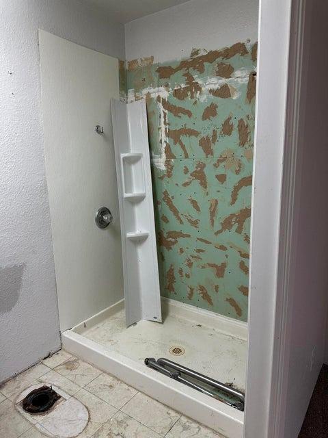 bathroom featuring tile patterned flooring and walk in shower