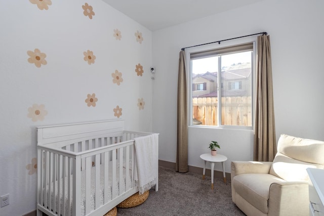 bedroom featuring a crib and carpet flooring