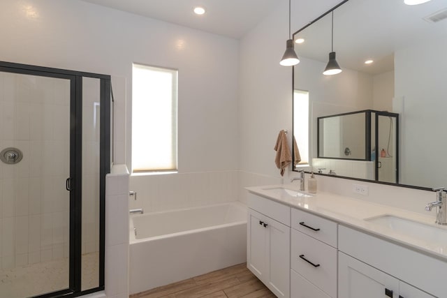 bathroom with wood-type flooring, vanity, and separate shower and tub