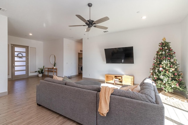 living room featuring ceiling fan and light wood-type flooring