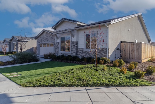 view of front of house with brick siding, fence, a front yard, a garage, and driveway