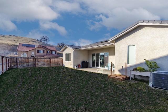 exterior space featuring cooling unit, a patio area, and a yard