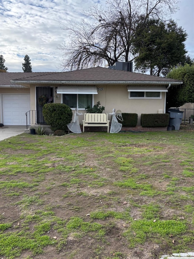 view of front of home with a front yard and a garage