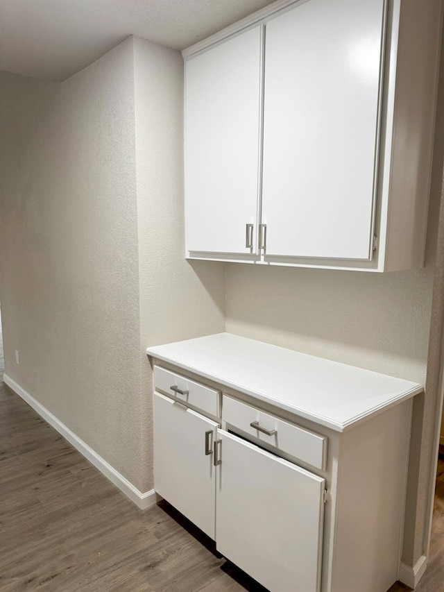 bar featuring baseboards and wood finished floors