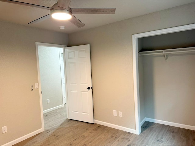 unfurnished bedroom with light wood-style floors, a closet, ceiling fan, and baseboards