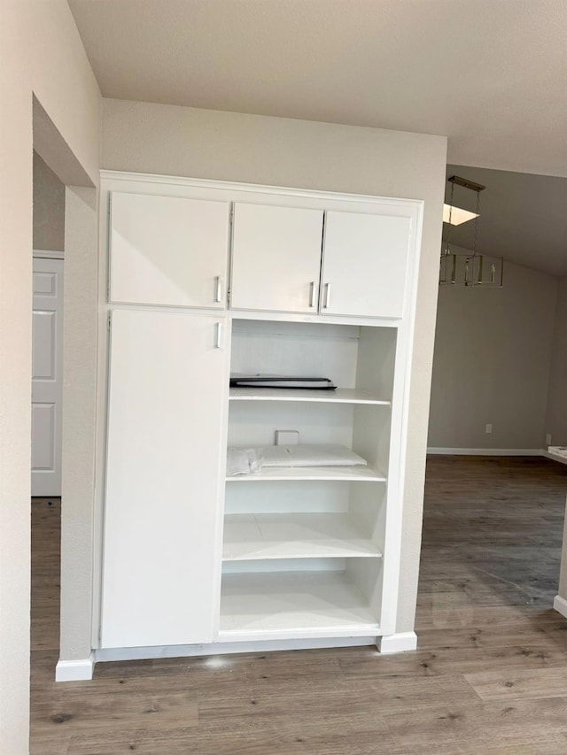 interior space with wood finished floors and baseboards