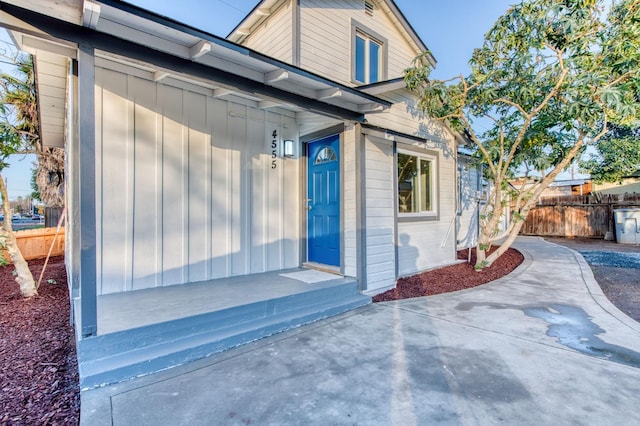 view of exterior entry with a patio area