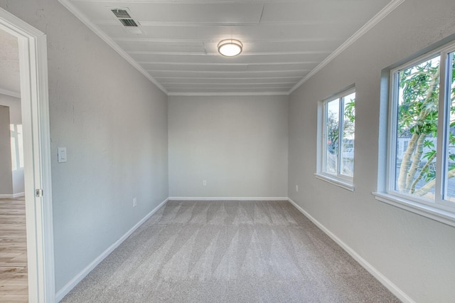 carpeted spare room with crown molding