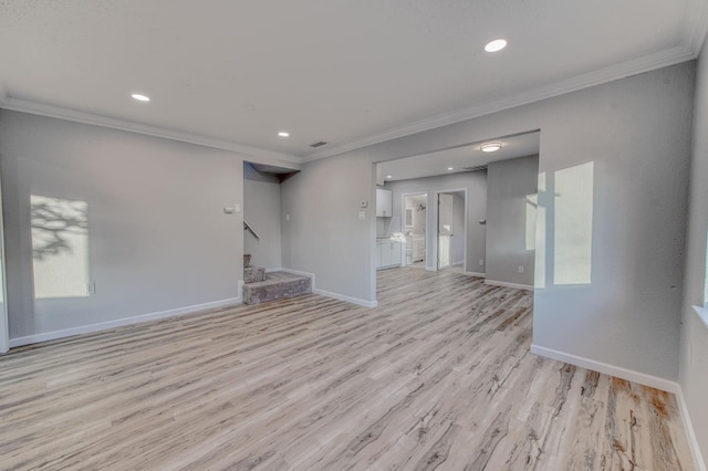 unfurnished living room featuring crown molding and light hardwood / wood-style flooring