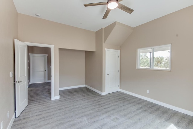 interior space featuring ceiling fan, light wood-type flooring, and vaulted ceiling