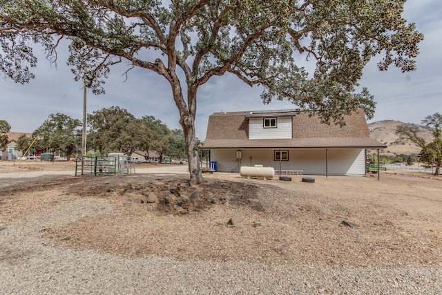 back of house featuring a mountain view