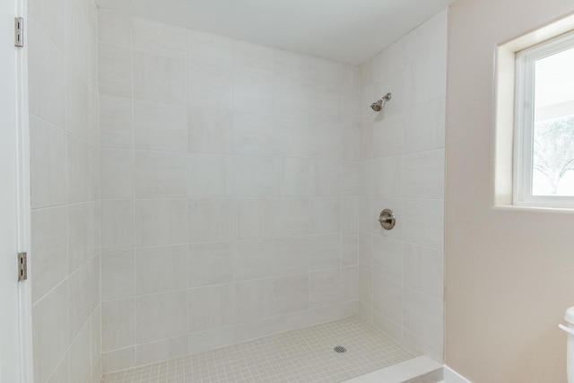 bathroom with tiled shower