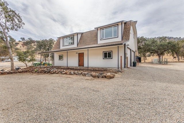 view of front of home featuring a porch and a garage