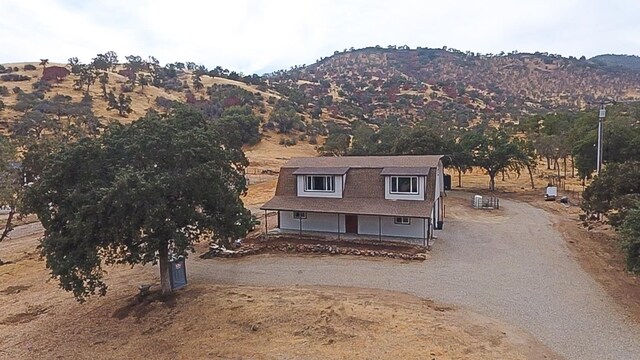 view of front of property featuring a mountain view and a porch