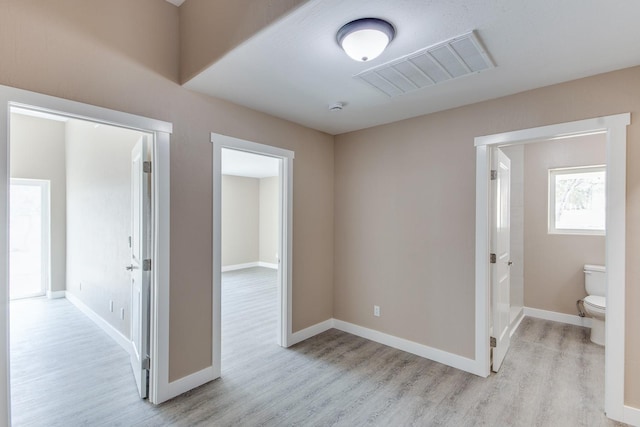 corridor with light wood-type flooring