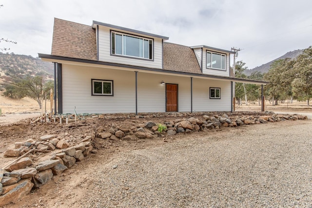 view of front facade with a mountain view and covered porch