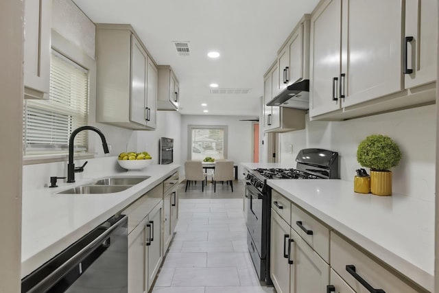 kitchen featuring plenty of natural light, light tile patterned flooring, sink, and stainless steel appliances