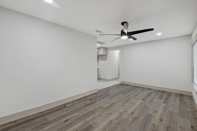 spare room with ceiling fan and light hardwood / wood-style floors