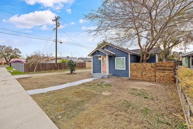 bungalow-style house featuring a front yard