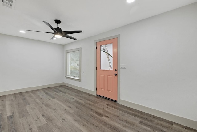 empty room with ceiling fan and light wood-type flooring