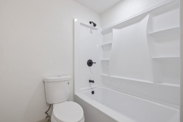 bathroom featuring bathtub / shower combination and toilet