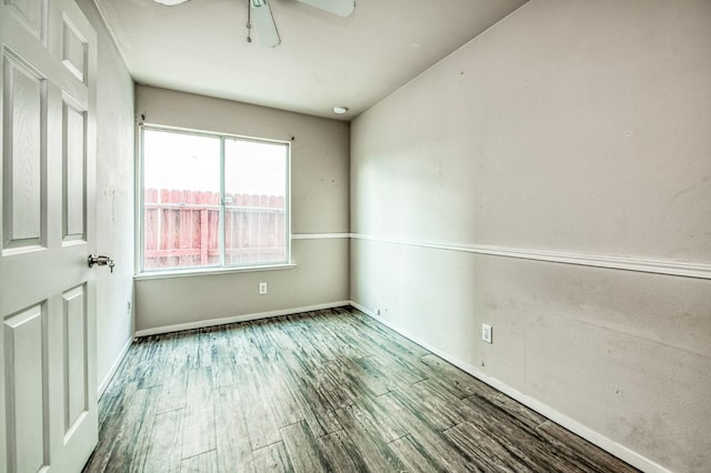 empty room with ceiling fan and hardwood / wood-style floors