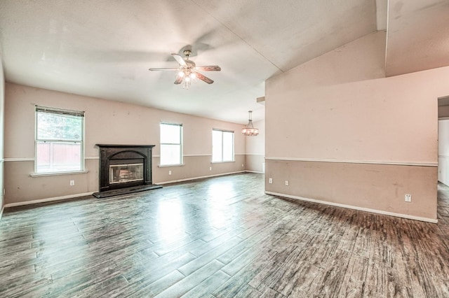 unfurnished living room featuring ceiling fan, dark hardwood / wood-style flooring, and vaulted ceiling