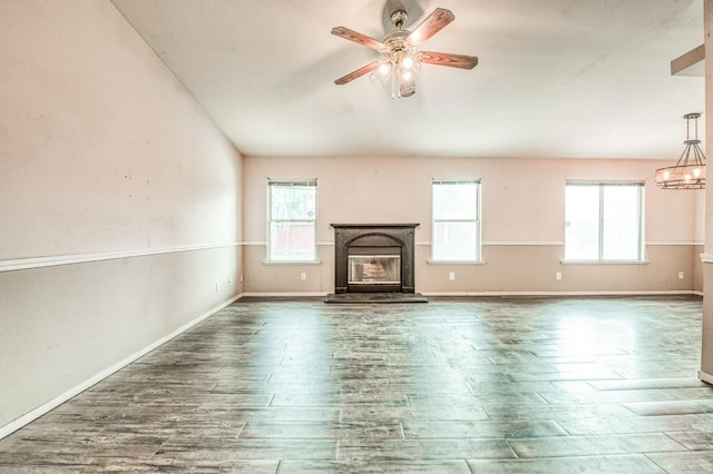 unfurnished living room with dark hardwood / wood-style flooring, plenty of natural light, and ceiling fan