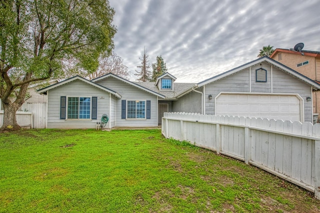 back of property featuring a lawn and a garage