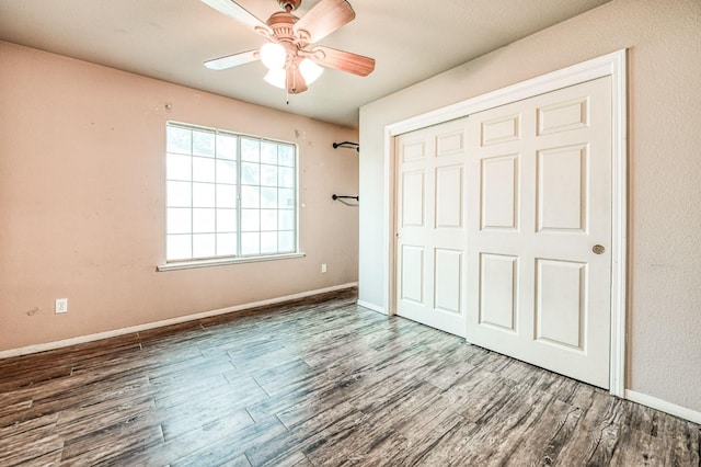 unfurnished bedroom featuring wood-type flooring, a closet, and ceiling fan