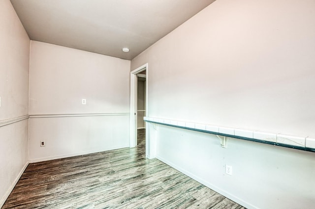 unfurnished room with wood-type flooring