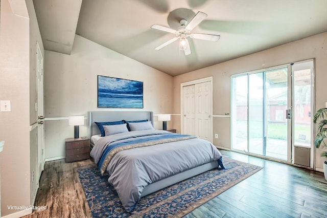 bedroom featuring access to exterior, ceiling fan, dark hardwood / wood-style flooring, lofted ceiling, and a closet