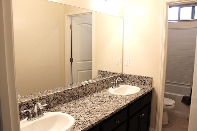 bathroom with vanity, tile patterned flooring, and toilet