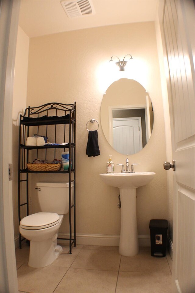 bathroom with tile patterned flooring and toilet